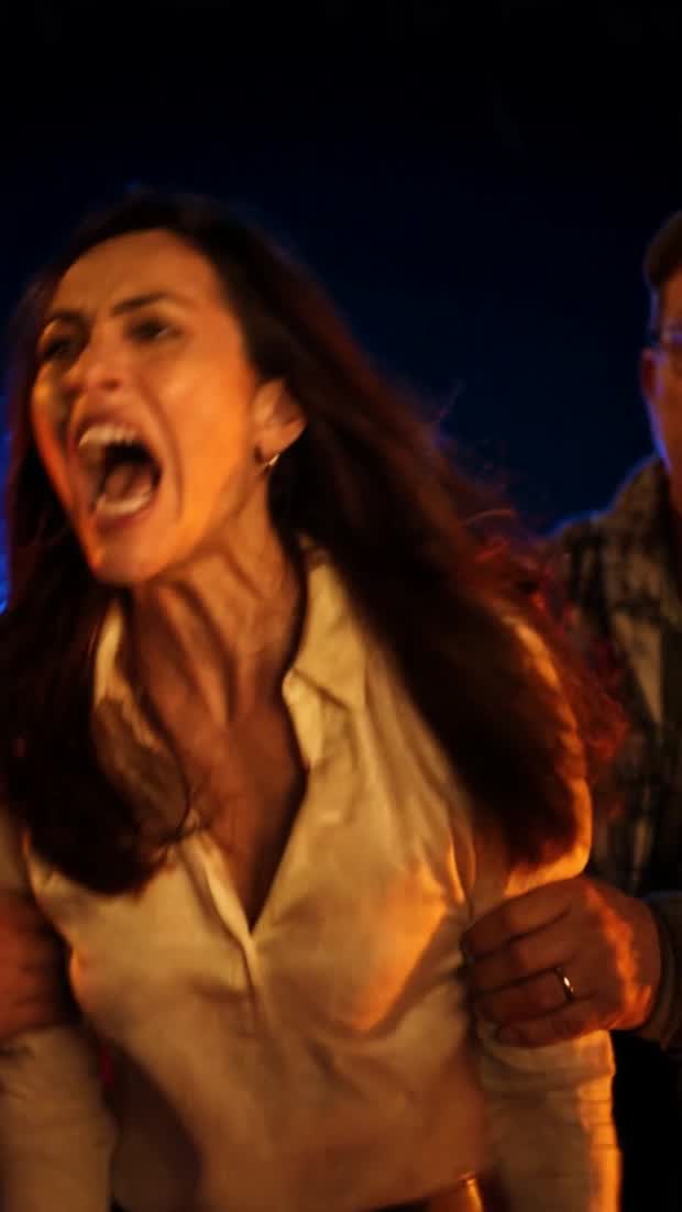 Double Wide Desires: a woman in a plaid shirt, close, unsmiling